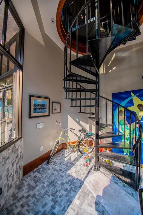 Front entrance has downstair landing and foyer area with custom tile and wrought iron staircase. An elevator also is available in rear entrance of building.