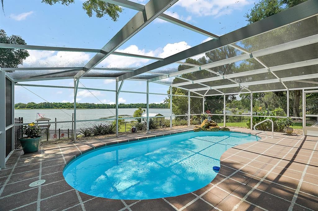 Gorgeous lake views from the 21x31 screened pool area, a hot tub, and a 16x16 sun patio.  The perfect place for B-B-Qs.