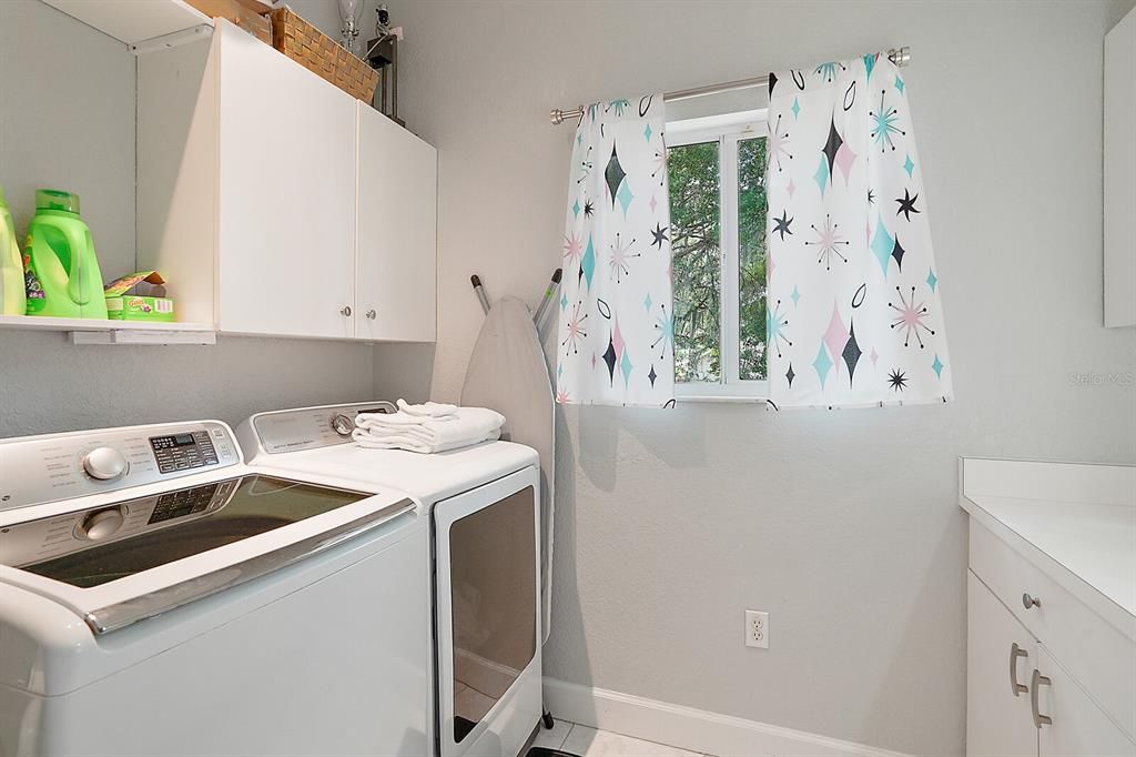 Laundry room with sink and storage.