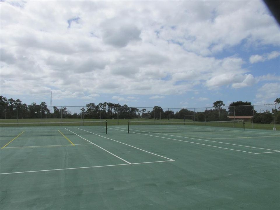 Tennis courts are located near the clubhouse.