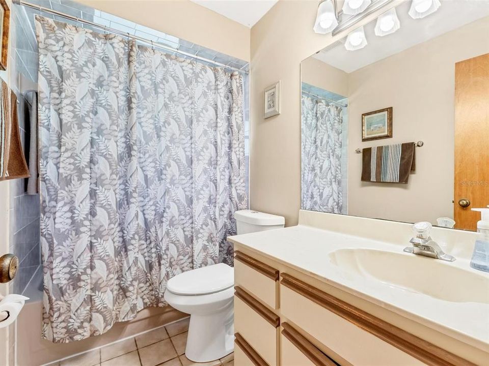 Guest bath offers a tub/shower combo and large vanity area.