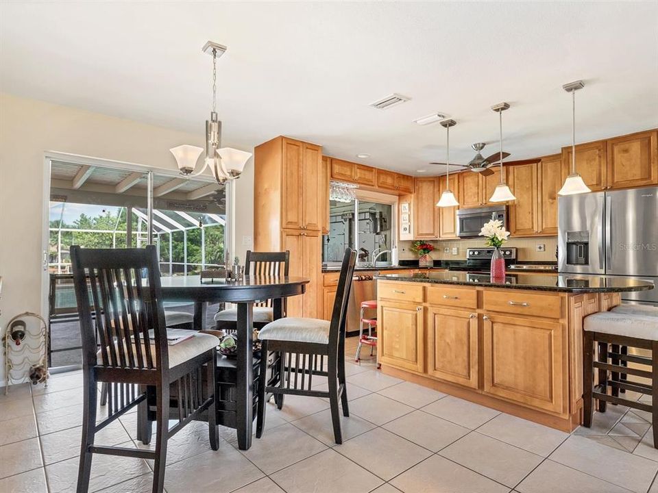 Dining and kitchen area features loads of nice wood cabinetry for abundance of storage!