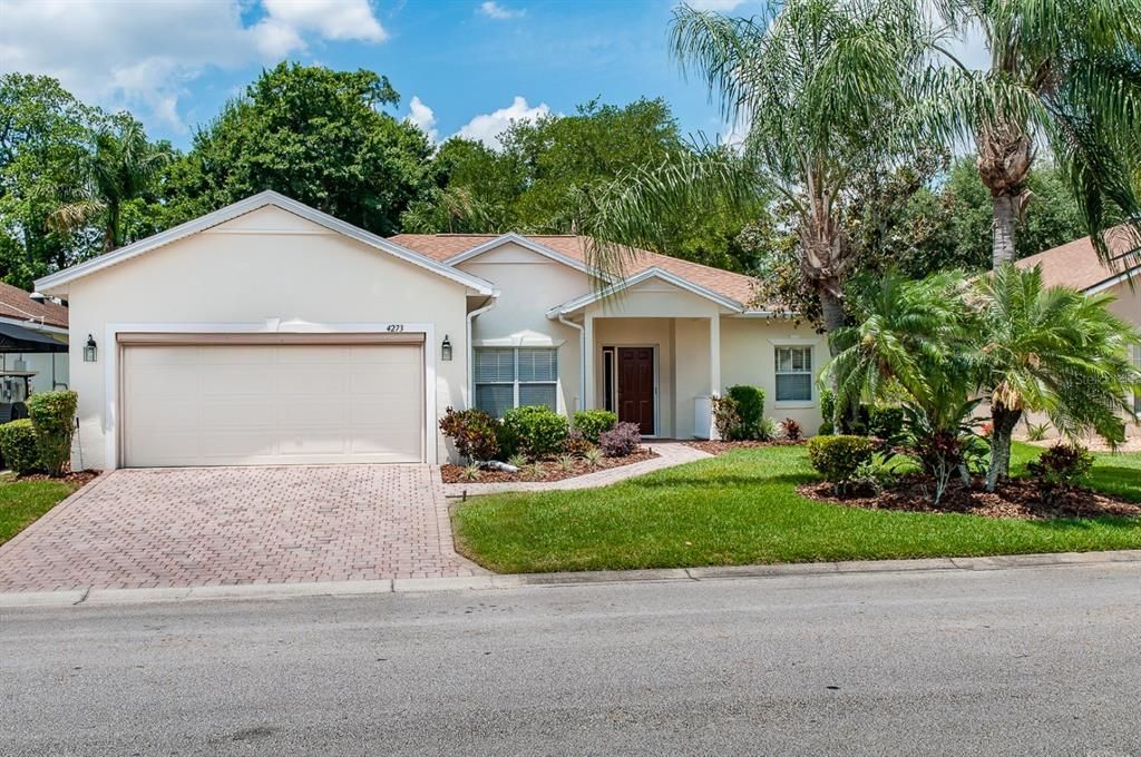 This DEVON floor plan home has great curb appeal from the quality plantings and palms.