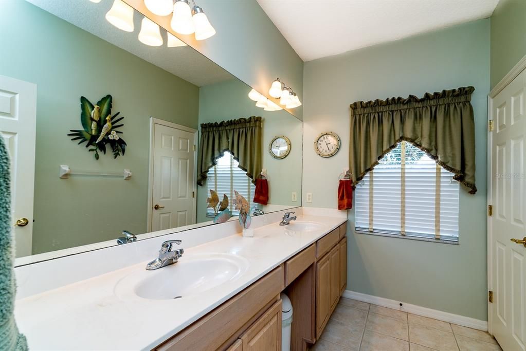 The master bath has 2 sinks in a cultured marble top on oak vanities. Better lighting fixtures are a plus.