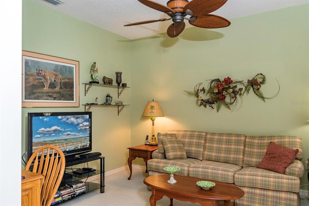 Just off the dinette is the den with its quality carpeting and designer ceiling fan.