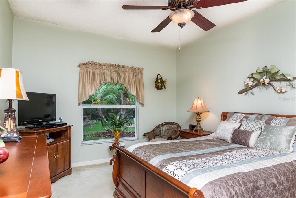 The master bedroom has a custom ceiling fan with light and quality carpeting.