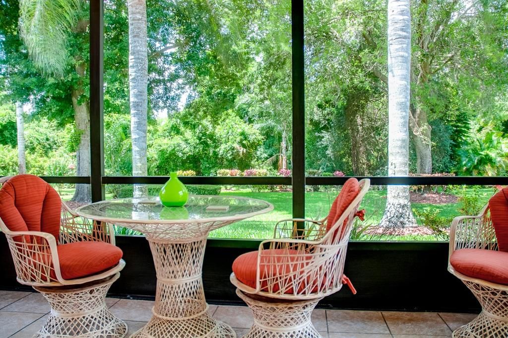With such a peaceful backyard, spending time in this screened and covered lanai has a most calming effect.