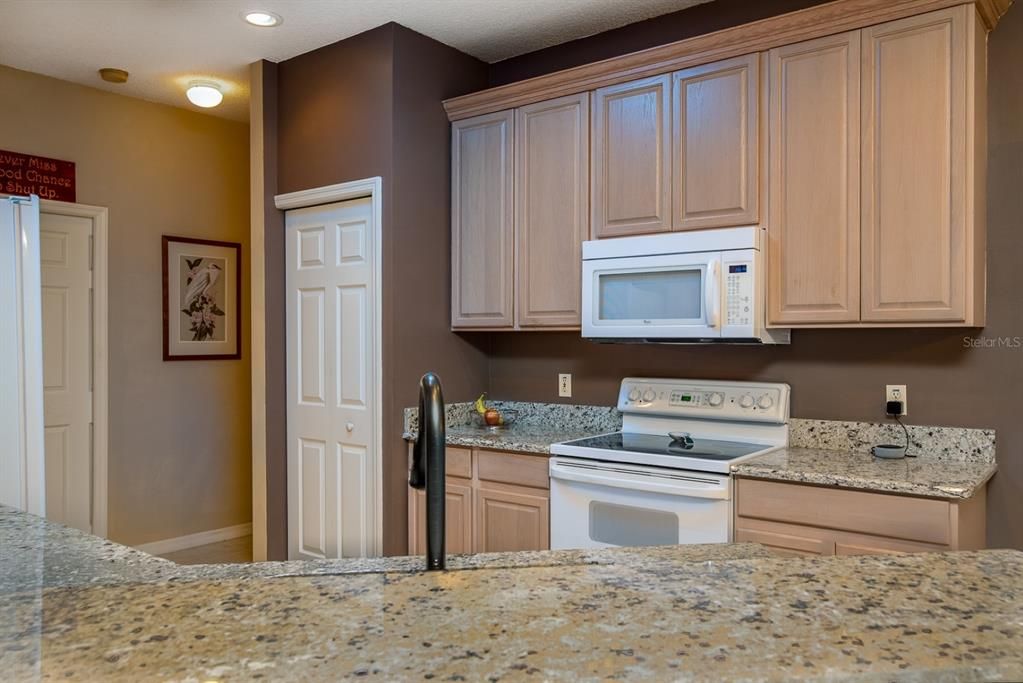 The kitchen has a closet pantry, granite counters, washed oak cabinetry with 42" uppers and crown.