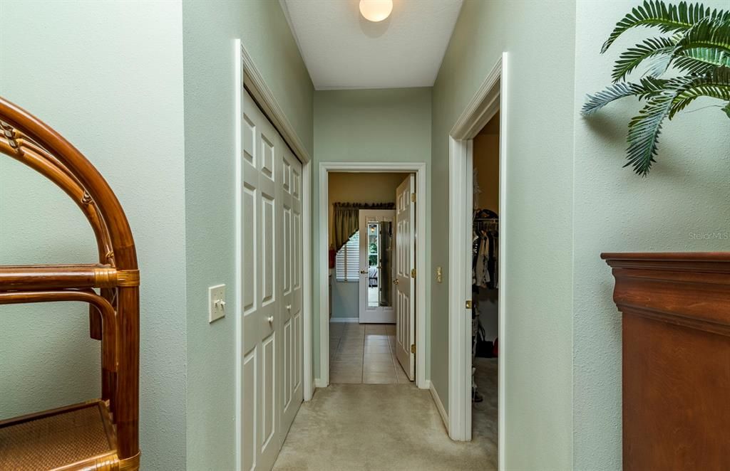The hallway in the master suite between the bedroom and bath holds the large walk in closet on the right and a reach in closet on the left.