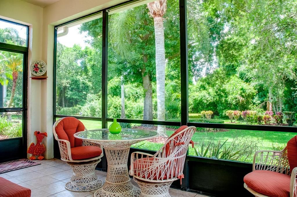 The view from the covered and screened lanai benefits from the nature preserve directly behind this home.