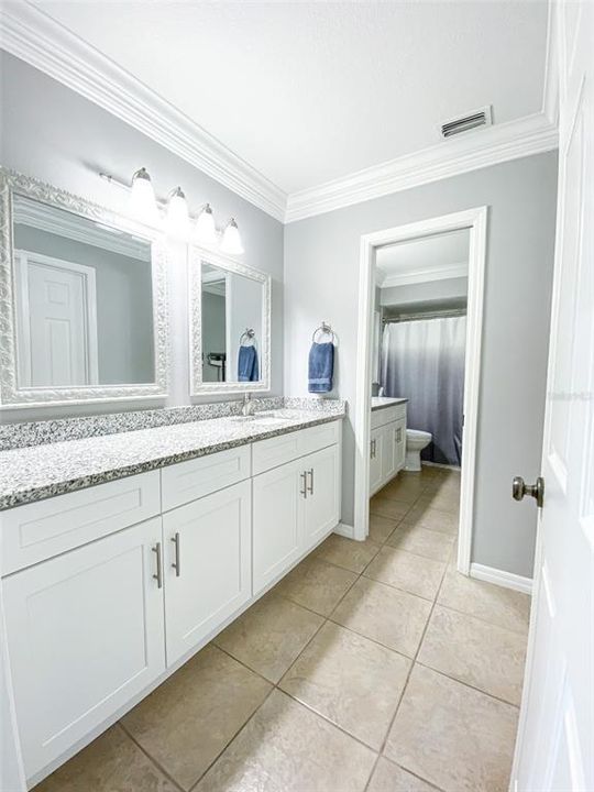 Light and airy design with two vanities and sinks.