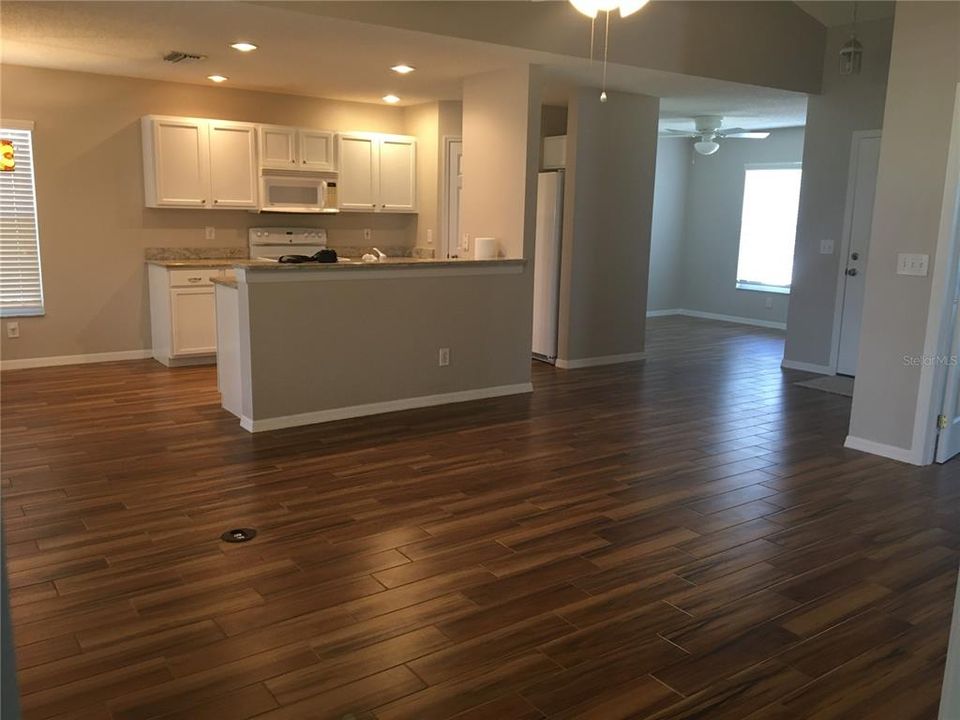 Kitchen, great room and den/dining room with ceiling fan