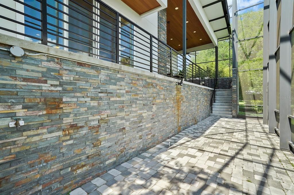 Screened area to backyard - Stone wall with copper