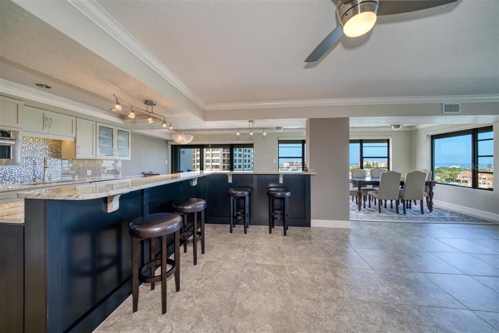 Open concept kitchen featuring a fabulous bar with plenty of seating