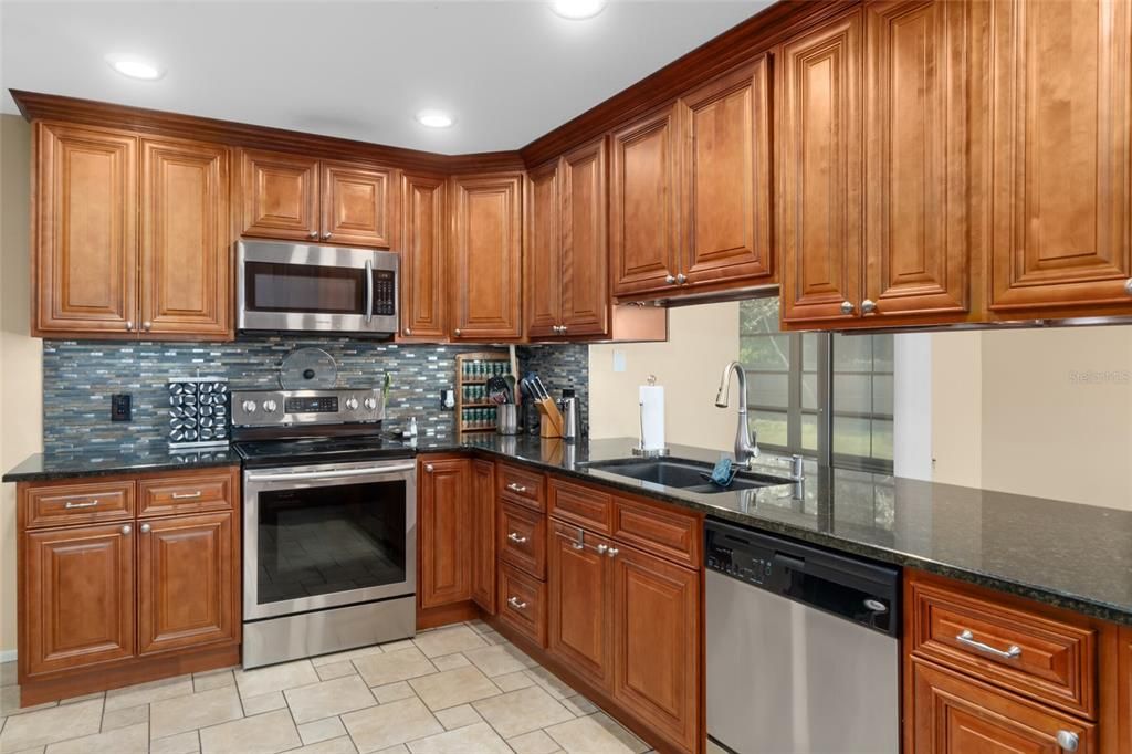The Kitchen Cabinets are just Beautiful with Gorgeous Moldings. Notice the Newer Stainless Steel Appliances