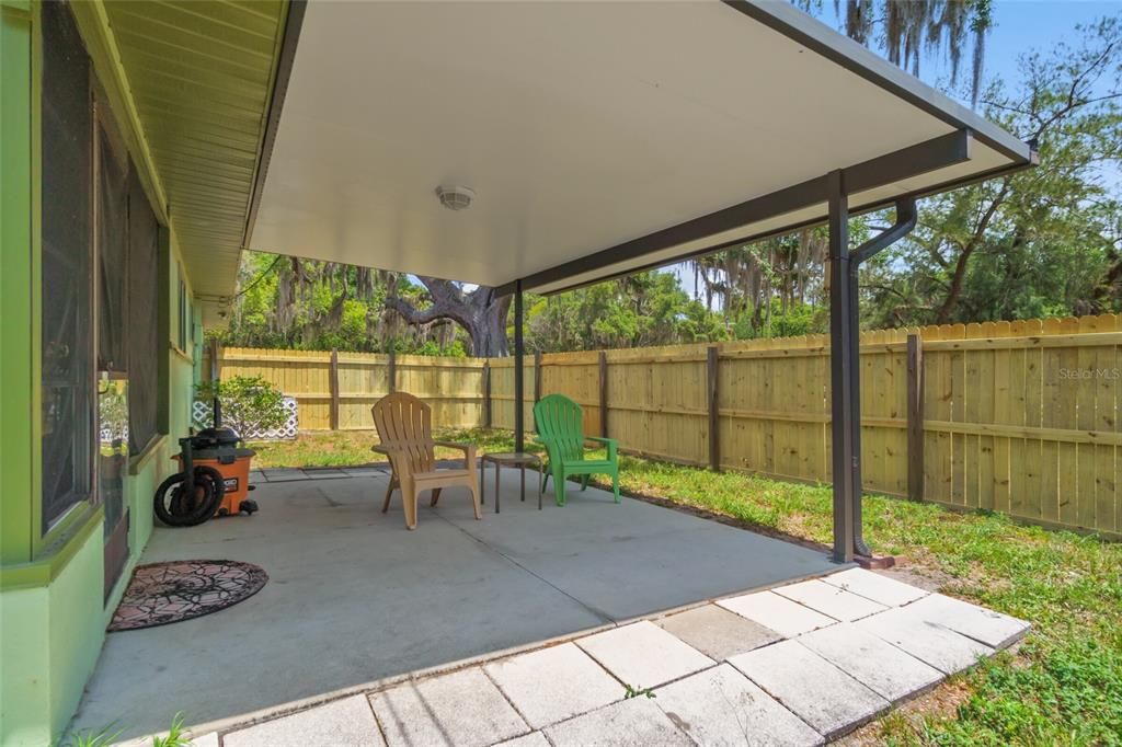 Wonderful Open Covered Patio, Great for Grilling or just Enjoying the Back Yard. Notice the New Wooden Fencing and New Gate