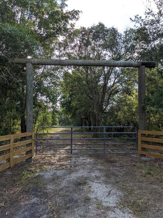 Ranch style gated entrance and new fence.