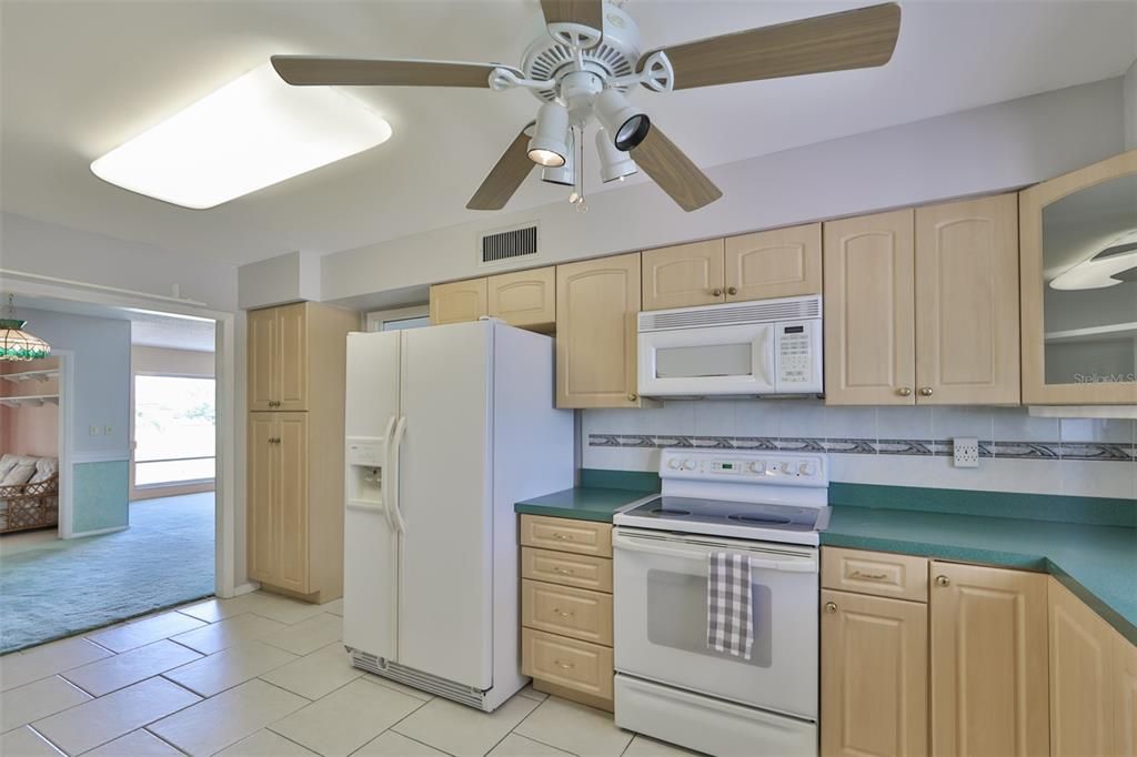 The Kitchen is nicely appointed with light cabinets and tiled backsplash.