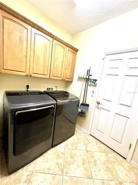 Laundry room with large washer/dryer.