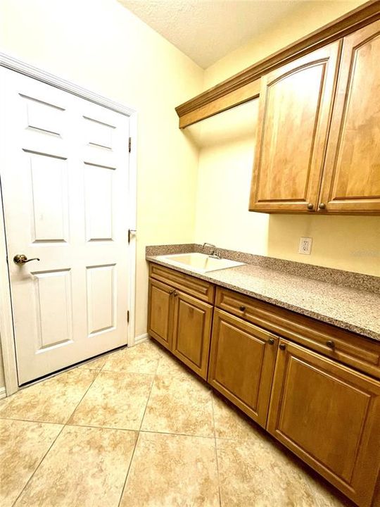 Laundry Room with sink and cabinetry