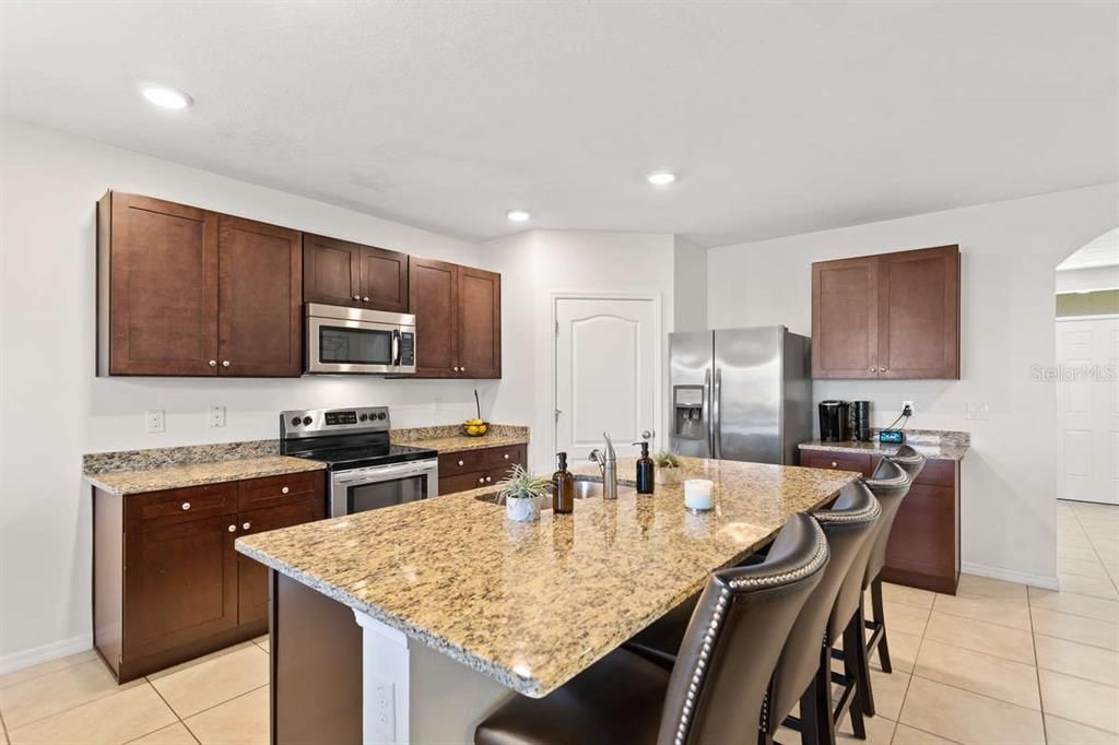 The kitchen with your granite countertops and stainless steel appliances.