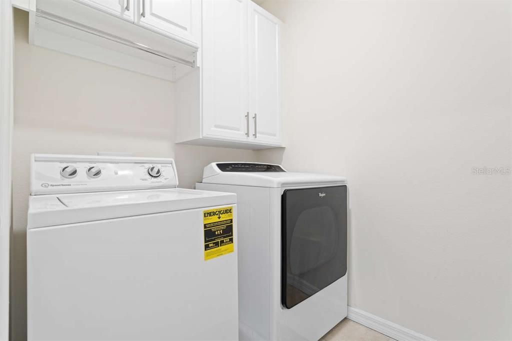 Upstairs laundry room with cabinets