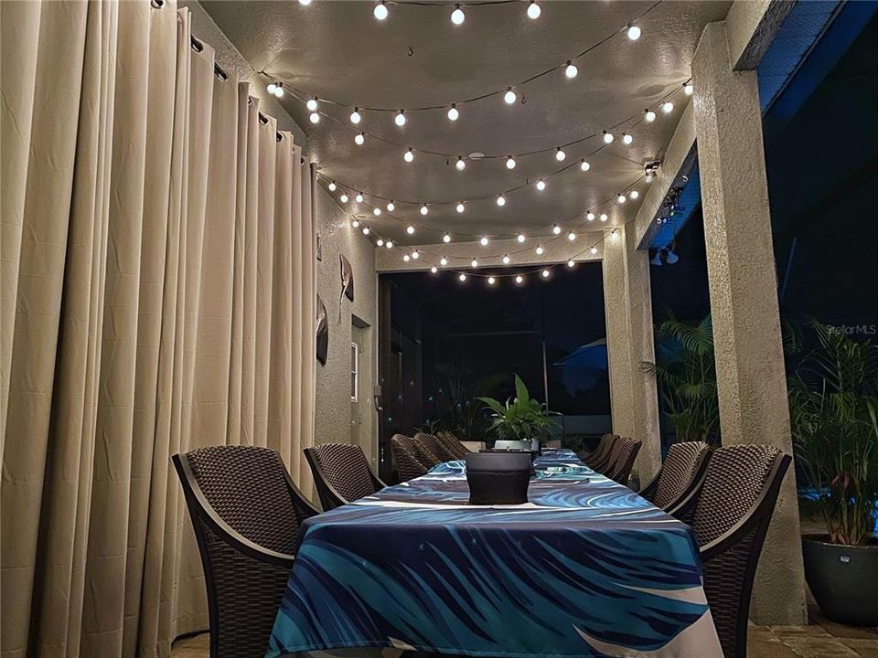 Cafe lights decorate the entire L shaped covered porch area