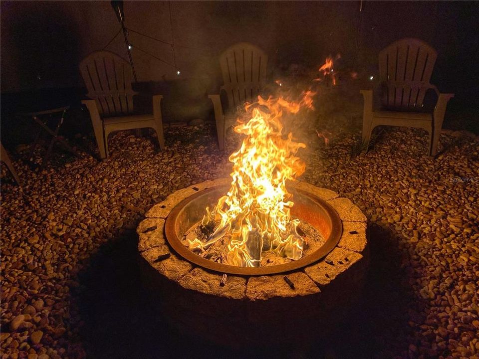 Backyard firepit has seating for 10 complete with tiki torches