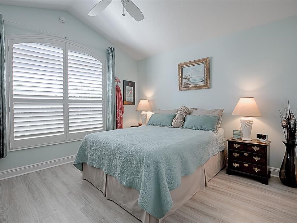 BEAUTIFUL LIGHT FLOORING AND PLENTY OF NATURAL LIGHT IN THIS GUEST BEDROOM, PLANATION SHUTTERS HERE AS WELL!