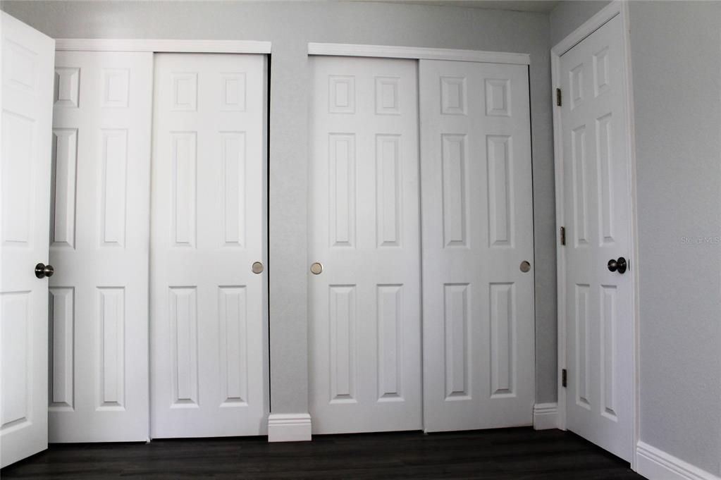 Double closets in the master bedroom. Master bath entry on the right.