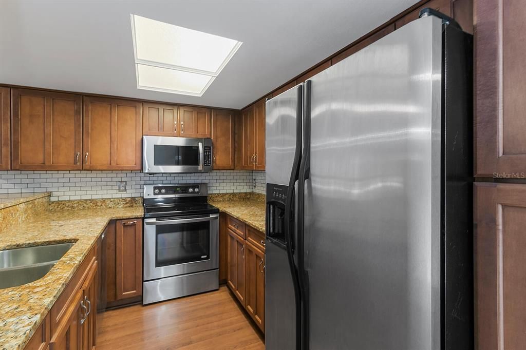 Wood cabinets, granite counters, stainless steel appliances.