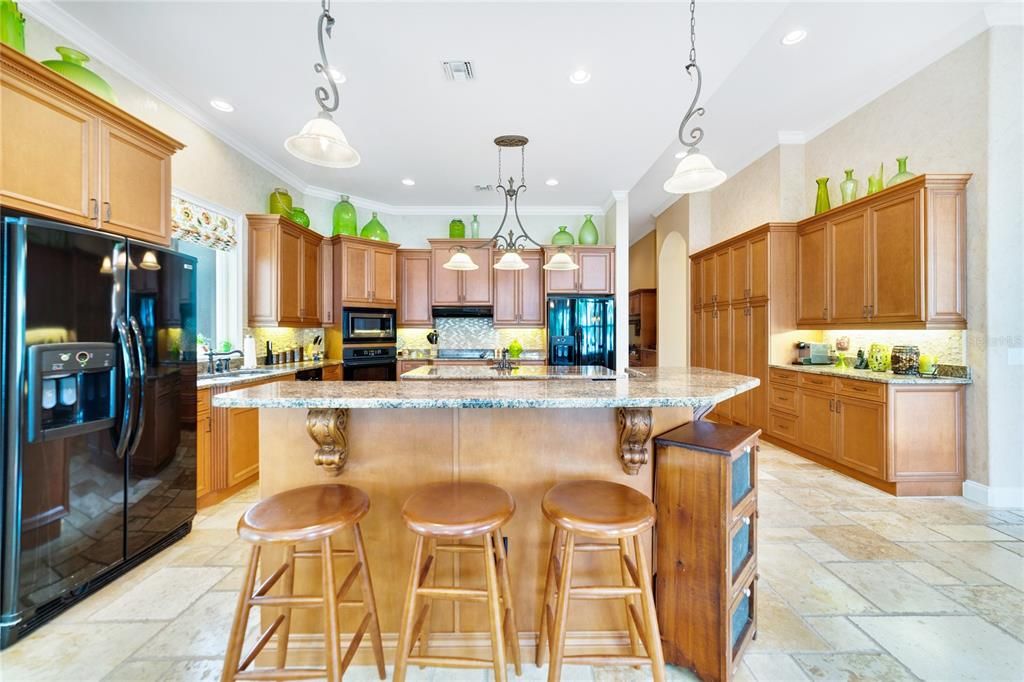 Kitchen boasts granite counters, dual refrigerators, walk in pantry and tons of prep and cook space!