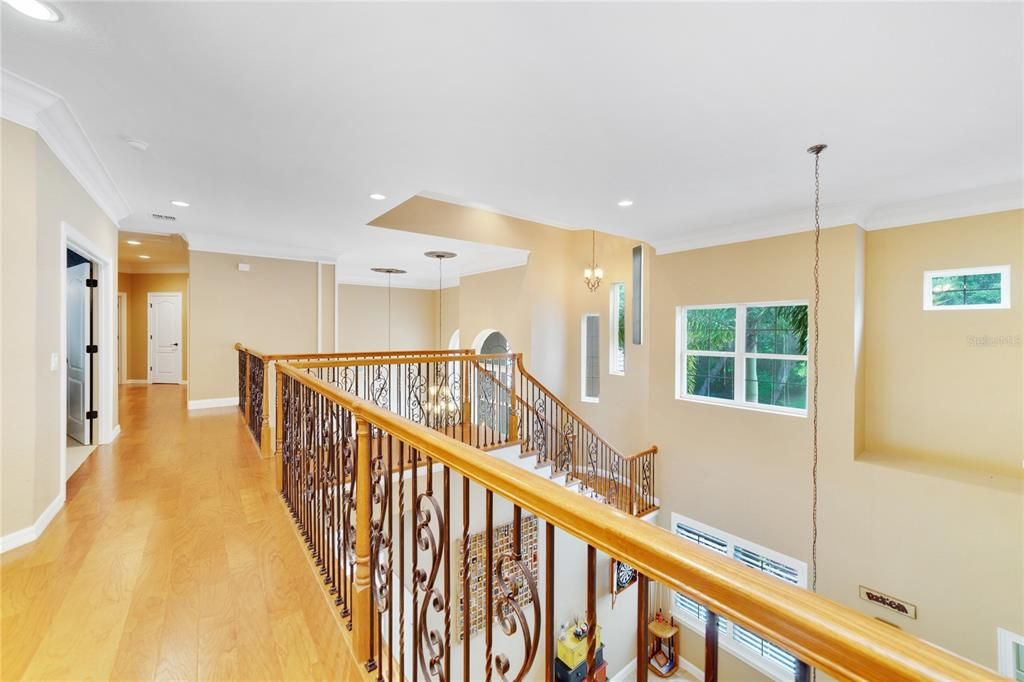 Walkway upstairs to home theater room, additional bedrooms and two additional full bathrooms.