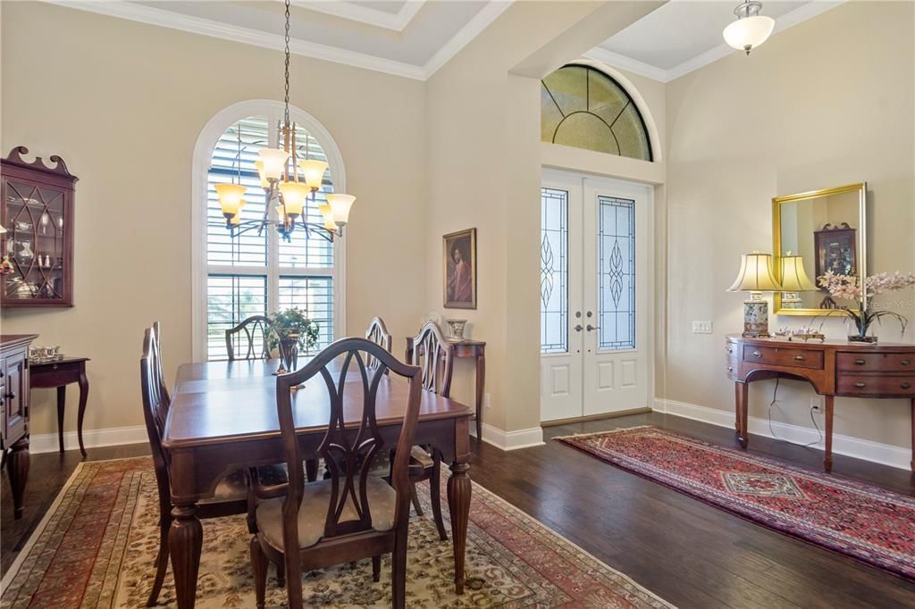 Dining room shows plantation shutters, cove molding and space for all the formal furniture dining pieces.
