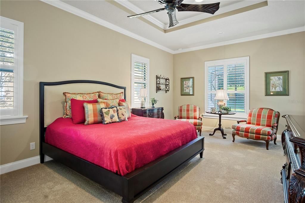 Master bedroom is private and elegant with seating area, new carpet, and ensuite bathroom.