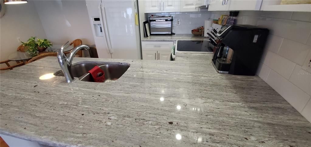 Unique granite with lots of counter top in this functional kitchen