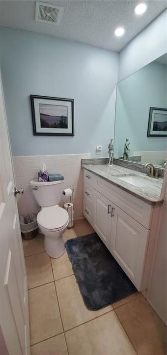 Main Bathroom with full size vanity and same granite as kitchen