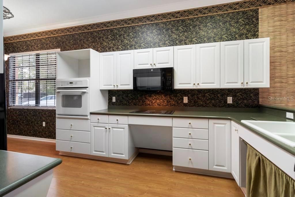 Kitchen features accessible cooktop and sink and wall oven