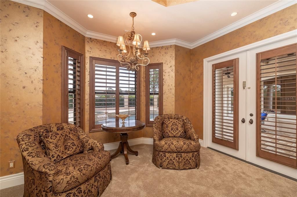 Sitting area in master suite for relaxed down time and French doors for easy access to the pool and spa.