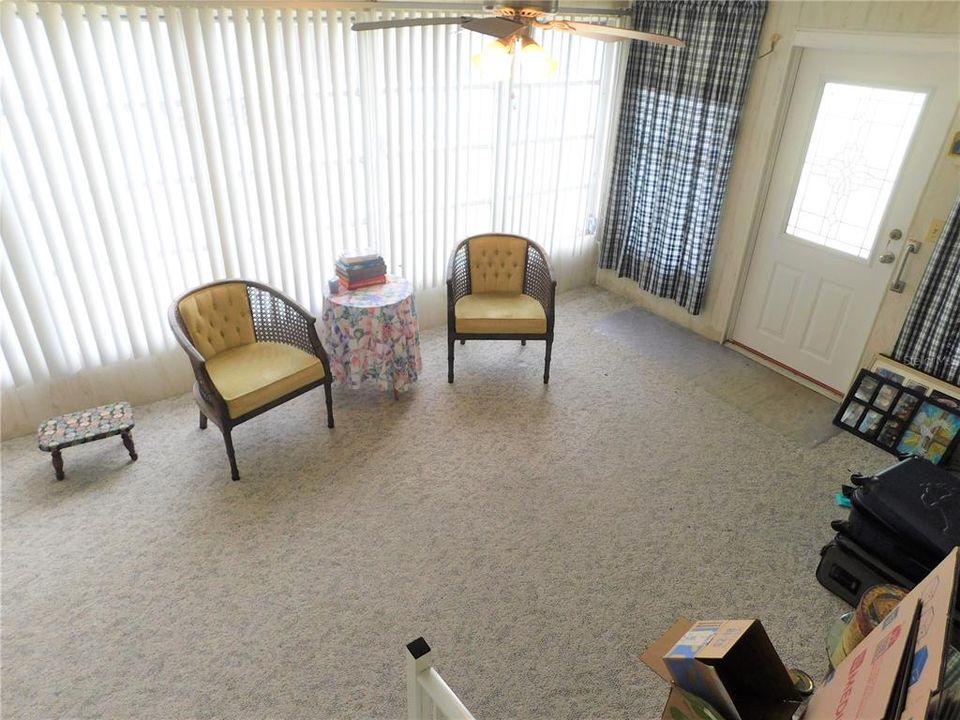 Enter into Florida room off the carport. Note a newer door was installed and Berber carpeting.