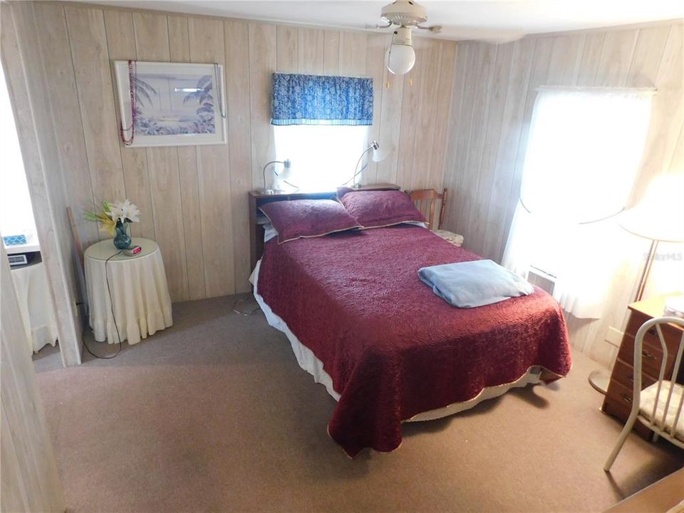 Master bedroom has ceiling fan, walk-in closet, and carpeting.
