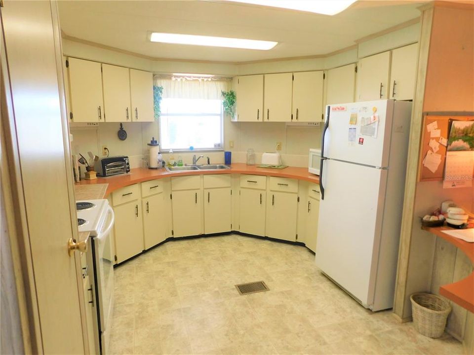Large open kitchen with plenty of counter tops and storage.
