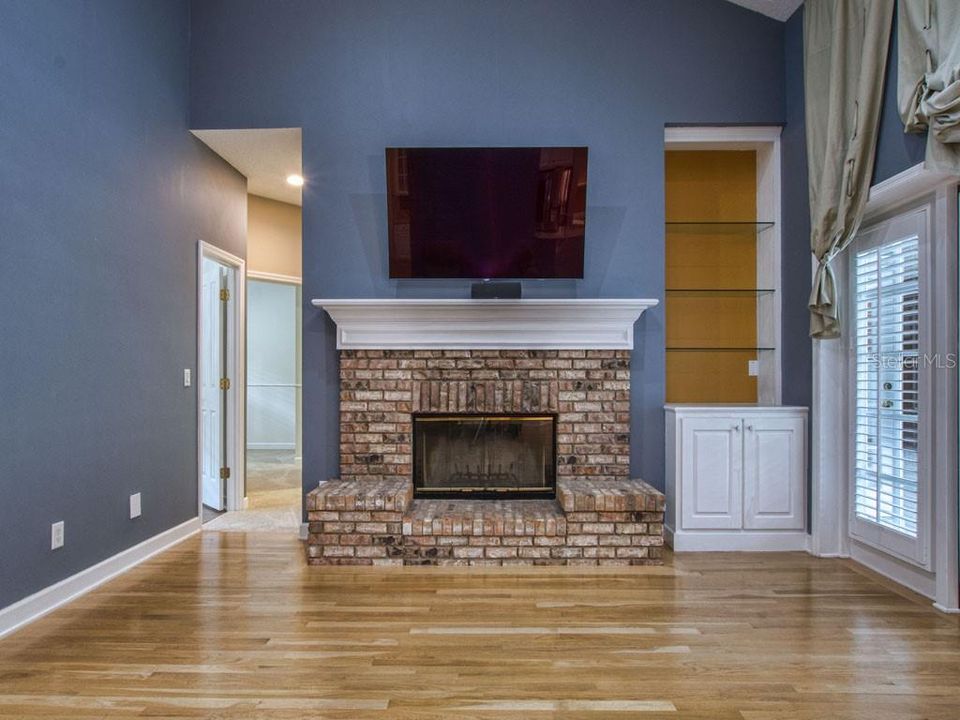 Brick Hearth outlines the majestic fireplace topped with a massive mantel and TV area.