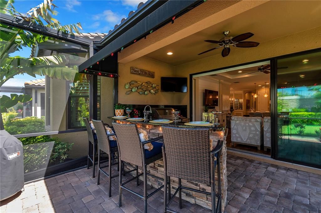 Sealed pavers, automatic retractable awning and stone work all around the outdoor kitchen.