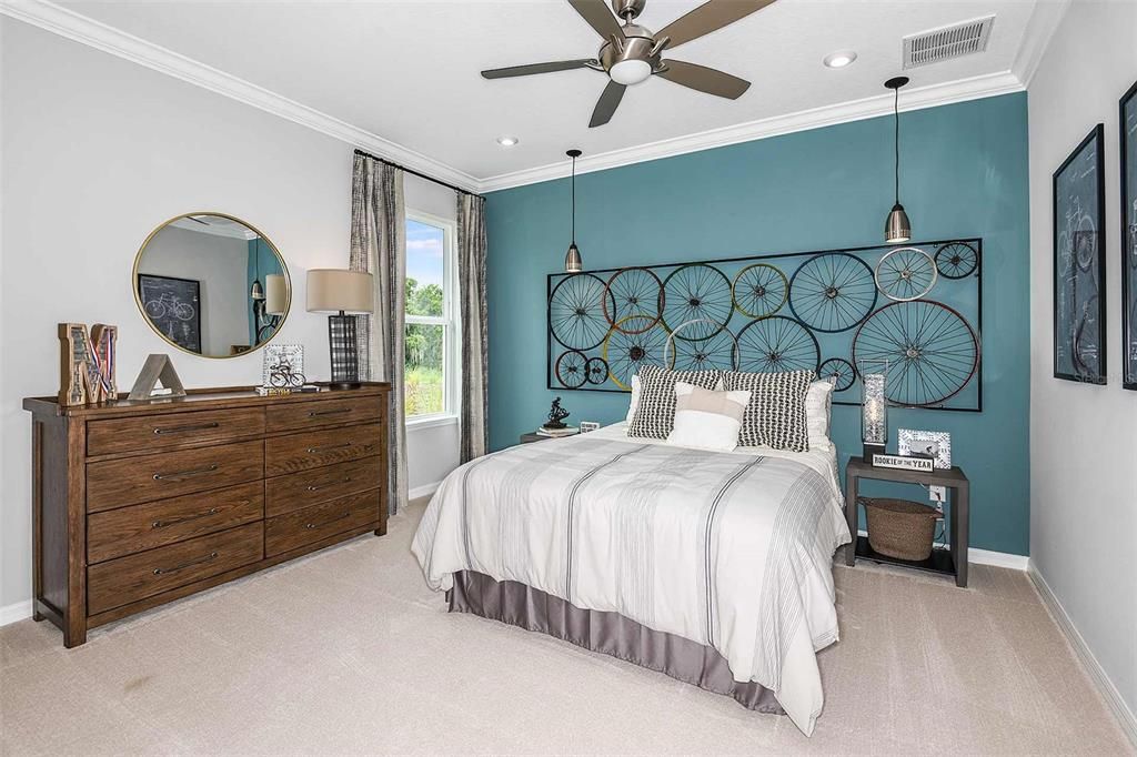 REPRESENTATIVE PHOTO. Plush carpet and natural light adorn this well-designed secondary bedroom.