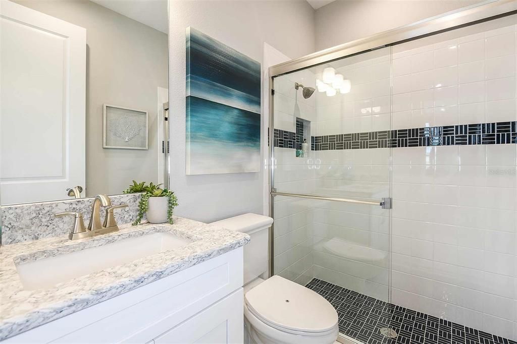 REPRESENTATIVE PHOTO. The secondary bathroom with a large walk-in shower, great storage vanity space and beautiful wall size mirror makes getting ready with ease in the morning.