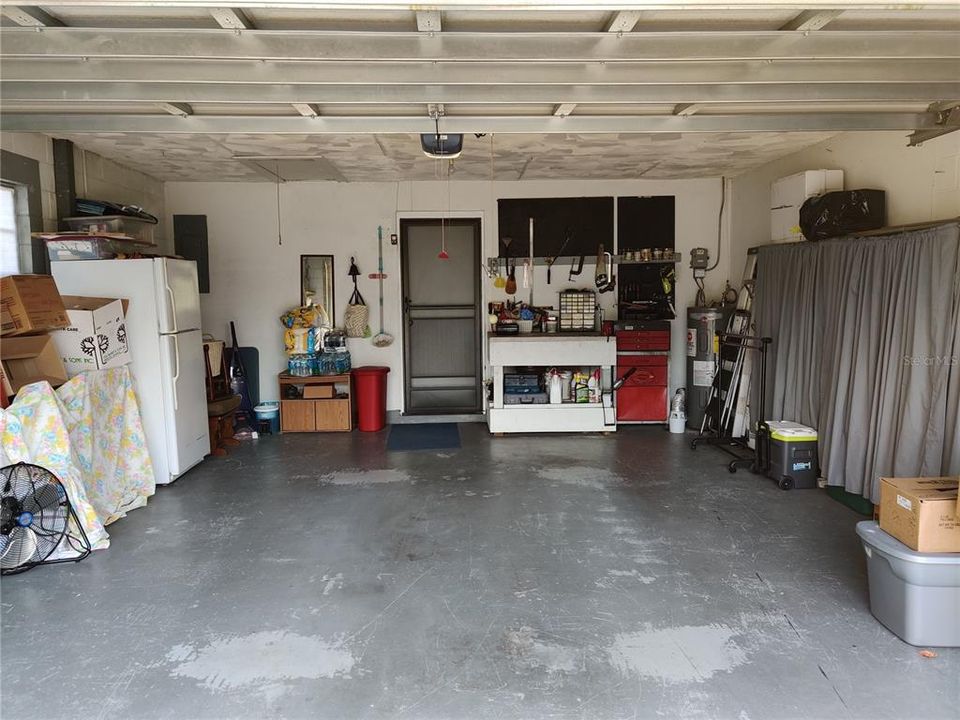 Large garage with work bench and shelves that stay Attic Access