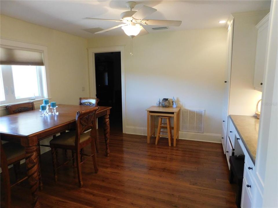 Multi-functional room off of kitchen, currently used as a dining room with office space.