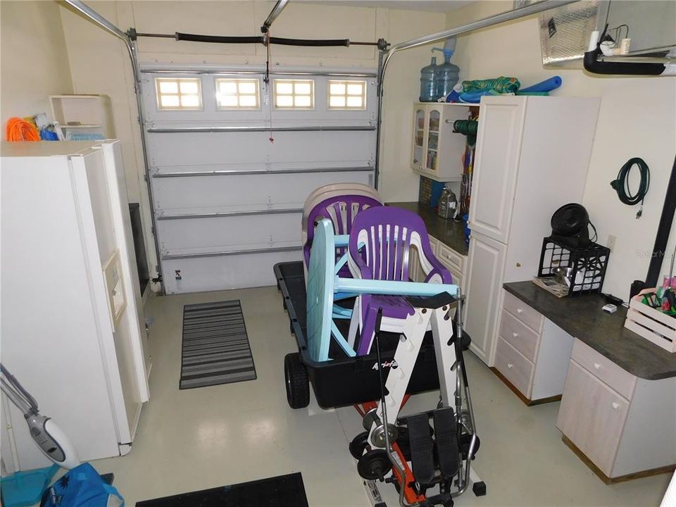 Expanded she-shed garage, workshop area with overhead door opener.