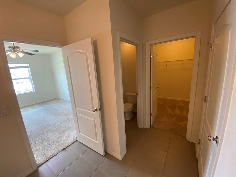 Master Bathroom showing toilet and walk-in Master Closet